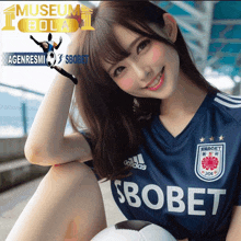 a girl wearing a blue soccer jersey that says sbobet