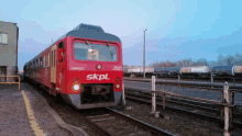 a red train with the word skpl on the front