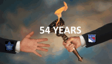 two hands holding a torch with the words 54 years written above them