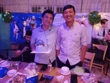 a man holding a can of pepsi stands next to another man holding a birthday cake