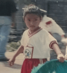 a young boy wearing a white shirt with a soccer ball on it