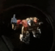 a blurred image of a toy robot in a dark room .