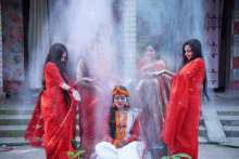 a woman in a red dress is surrounded by other women in red dresses