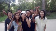 a group of people are posing for a picture and one of them is giving the middle finger