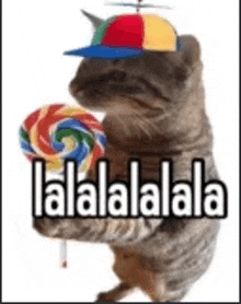 a cat wearing a hat and holding a lollipop with the words lalalalala written on it .