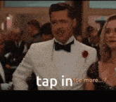 a man in a tuxedo is standing next to a woman and says tap in once more