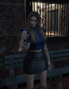 a woman in a blue top and black skirt is holding a cell phone in front of a brick wall