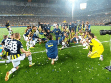 a group of soccer players kneeling on the field with one wearing the number 1438