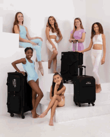 a group of young girls are posing for a picture with a suitcase that says ' tmc ' on it