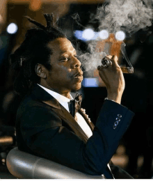 a man in a tuxedo smoking a cigar with smoke coming out of his mouth