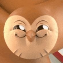 a close up of a cartoon owl 's face with a smile on its face .