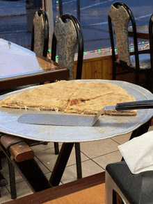 a pizza on a pan with a spatula on top