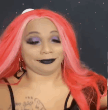 a woman with red hair and black lips is making a funny face