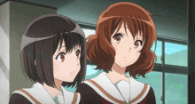 two anime girls standing next to each other in a room