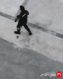 a black and white photo of a police officer walking down a street