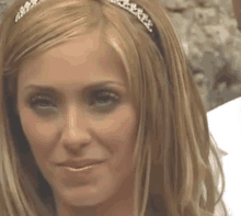 a close up of a woman 's face with a headband on her head