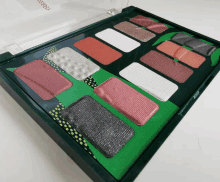 a palette of eye shadows has a green border