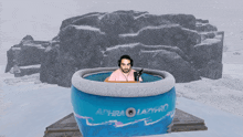 a man is sitting in an inflatable bathtub that says achra lazypro