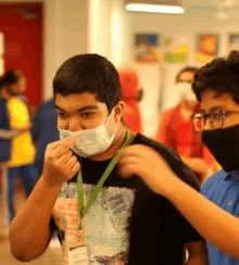 a man wearing a face mask and a name tag