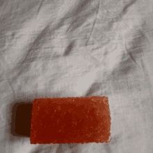 a piece of orange soap on a white cloth