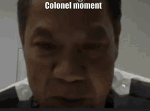 a close up of a man 's face with the words colonel moment above it