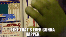 a green hand is pointing at a book with the words `` like that 's ever gonna happen '' written on it .