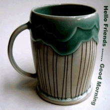 a green and white mug with the words " hello friends good morning " on the bottom