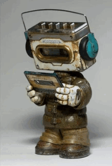 a statue of a robot holding a cassette tape