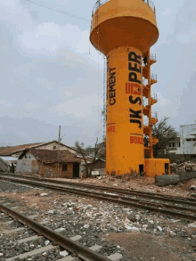 a yellow water tower that says jk super on it