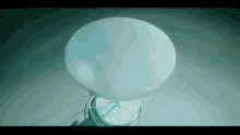 a large white sphere is sitting on a table in a dark room