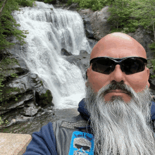 a man with a beard wearing sunglasses and a patch that says ' smoke & friends ' on it