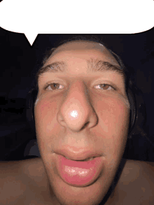 a close up of a man 's face with a white speech bubble above it