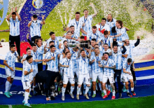 a group of soccer players are posing for a picture with a trophy