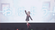 a girl in a school uniform is dancing on stage