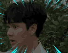 a close up of a young man 's face with a surprised look on his face surrounded by trees .