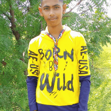 a boy wearing a yellow shirt that says born to be wild