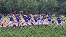 a group of baseball players are standing on a field and one of them is wearing a shirt that says ' warriors '