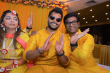 a group of people posing for a picture with their hands up