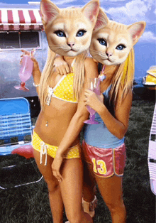 two women in bikinis with cats on their faces and shorts with the number 13 on them