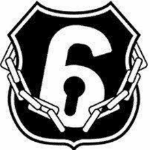 a black and white image of a shield with a keyhole and chains around the number six .