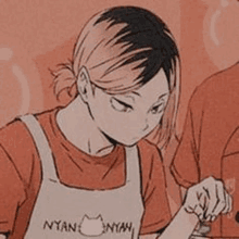 a girl in an apron is cooking in a kitchen .