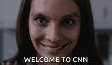 a woman is smiling with the words welcome to cnn behind her