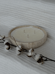 a candle in a bowl with three candles on it