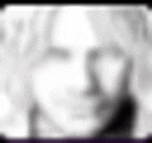 a blurry picture of a woman 's face with a purple border