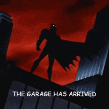 a cartoon of batman standing on top of a building with the words the garage has arrived below him