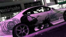 a white sports car with a purple design on the side is parked on the side of the road .