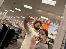 a man and a woman are taking a picture in a target store