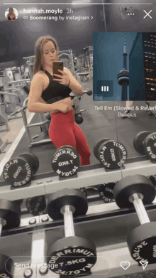 a woman is taking a picture of herself in a gym with dumbbells that say terramut