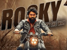 a man with a beard is riding a motorcycle in a movie poster .