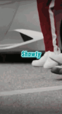 a person standing in front of a car with the word showty on the bottom